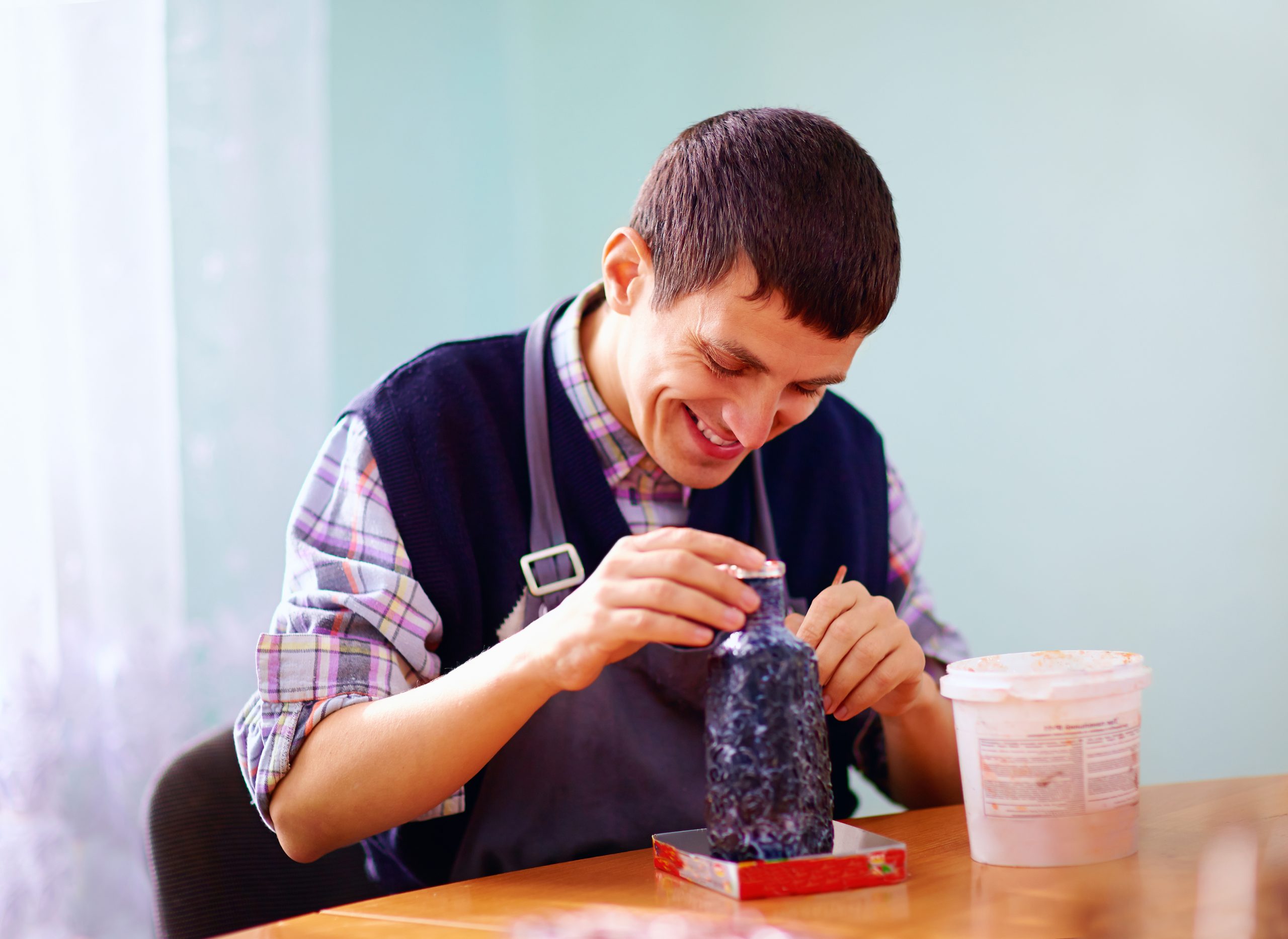 Young,Adult,Man,With,Disability,Engaged,In,Craftsmanship,On,Practical